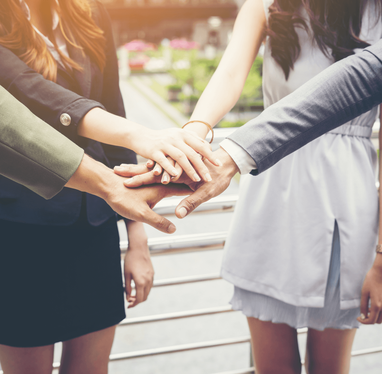 closeup-image-people-putting-their-hands-together-outdoors